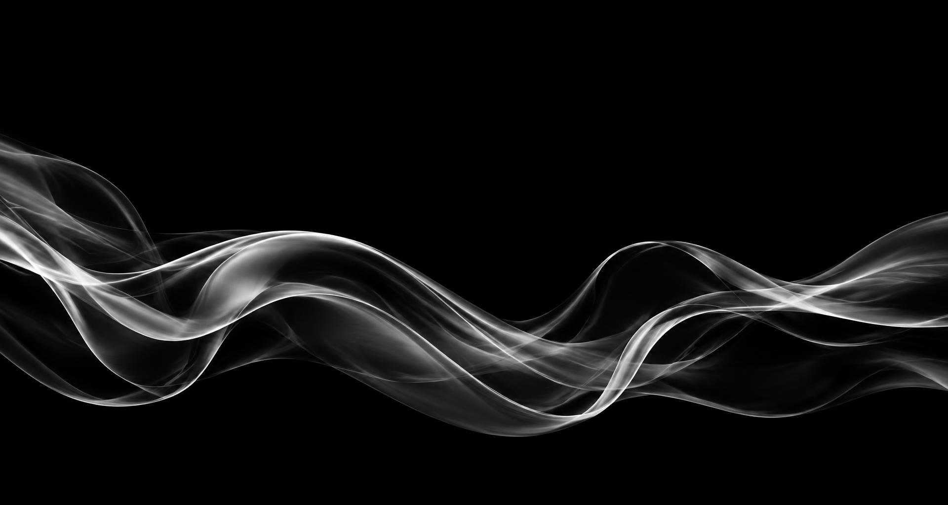 Flowing silver waves against black